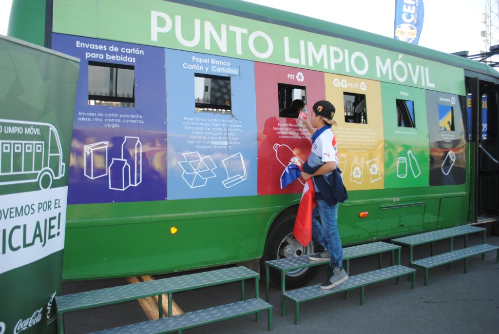 A mobile Punto Limpio, built from a bus. The recyclable material is deposited through the windows. Each window is inside a panel painted in a different color. Each color represents the type of material that window can receive.